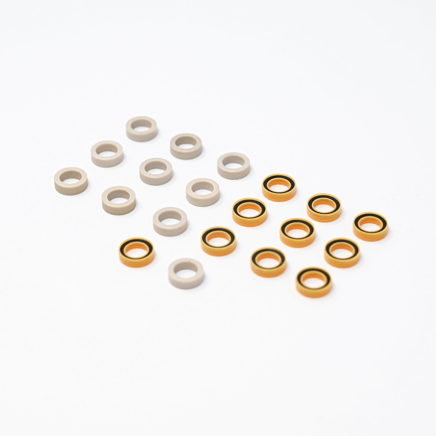 A collection of orange and white plastic seals arranged neatly on a surface, showcasing their vibrant colors and shapes.