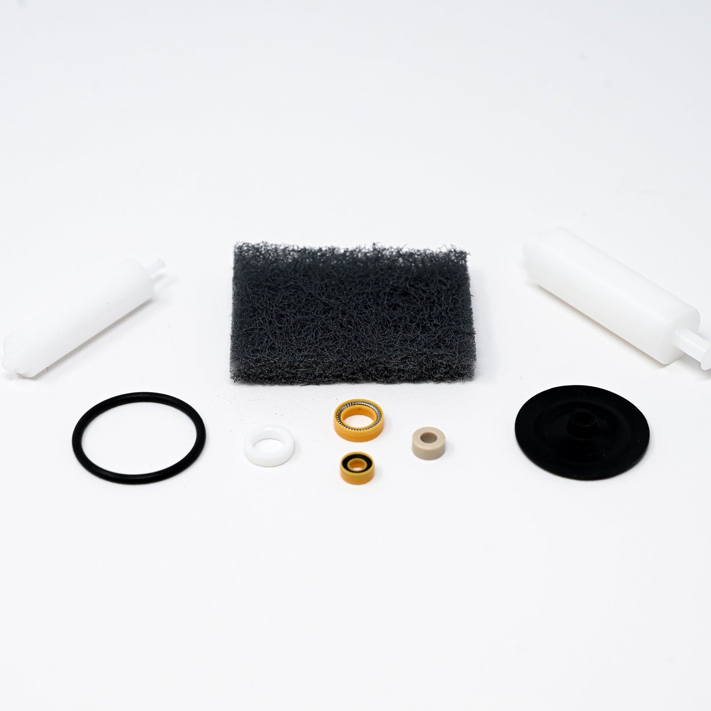 A collection of parts including seals, washers, bushings, o-rings, removal tools and scour pad.
