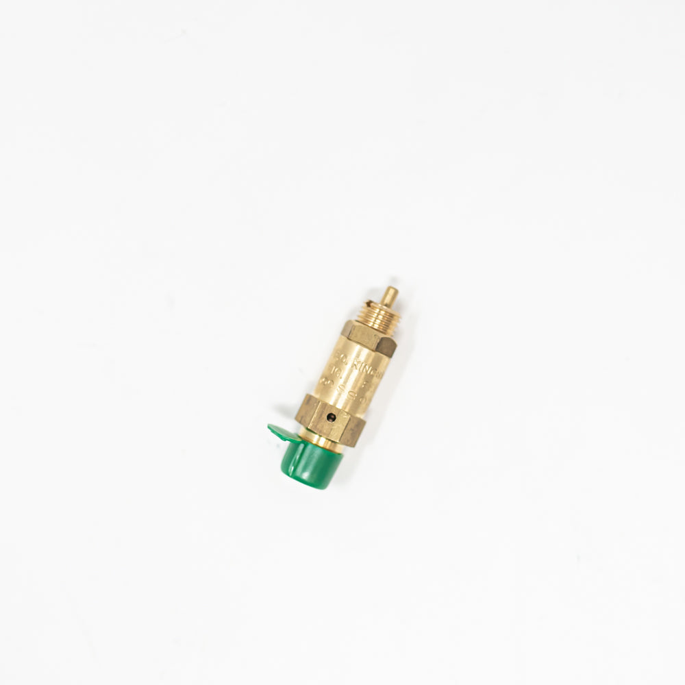 A small valve made of brass, enhanced by a green cap, reflecting its design and utility in a compact form.