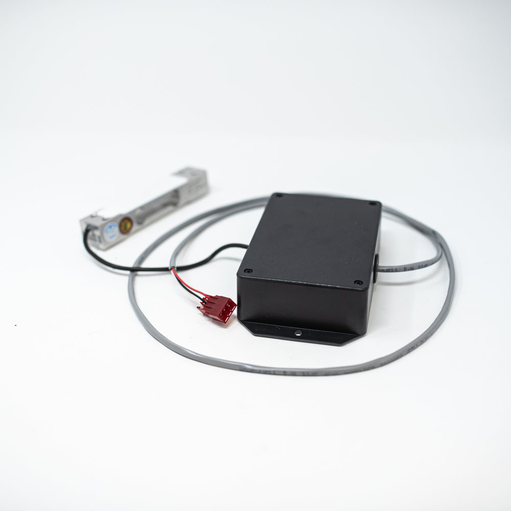 A compact black box featuring two attached cords, emphasizing a modern aesthetic.