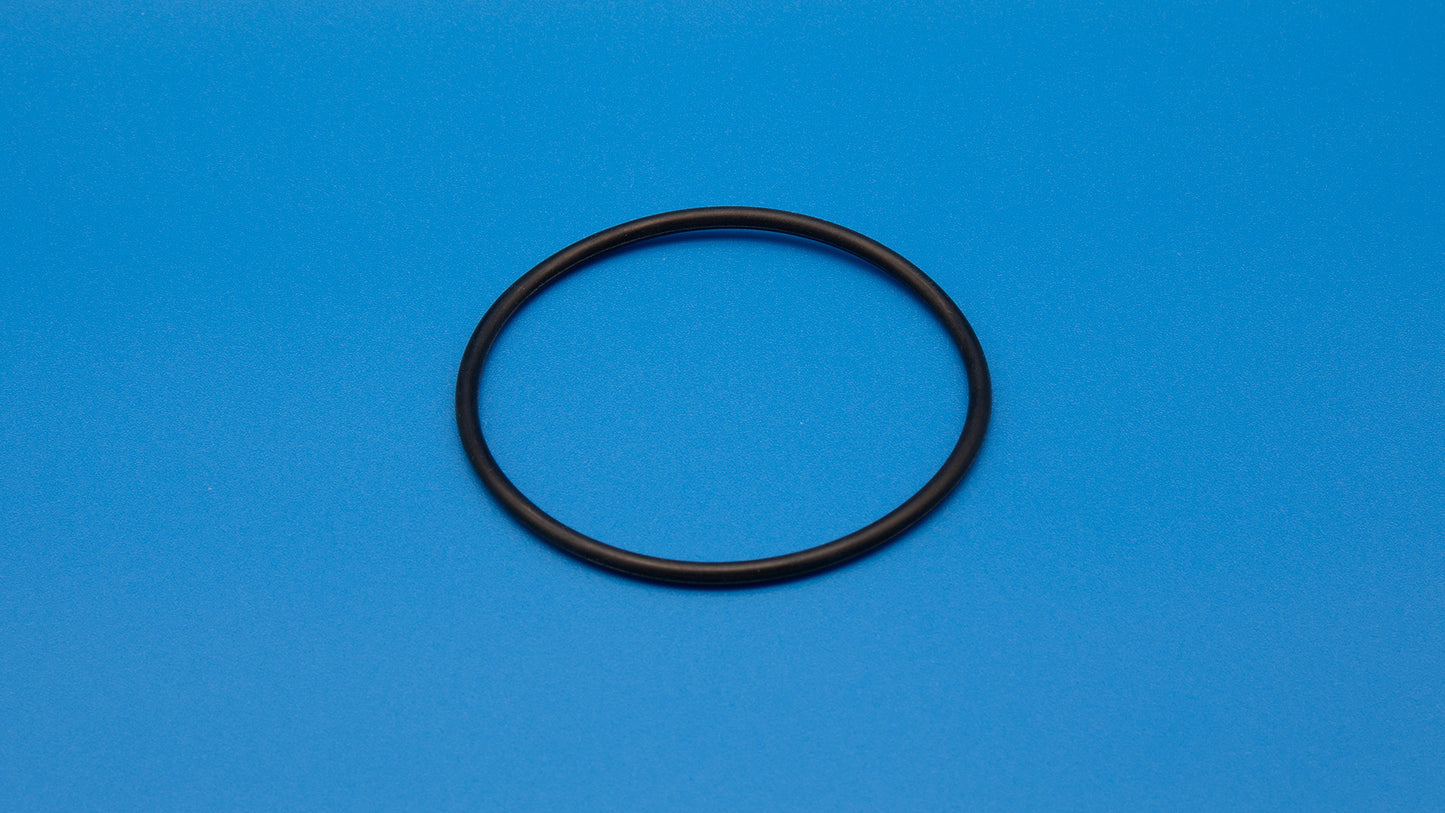 A black rubber O-ring positioned against a vibrant blue background, showcasing its circular shape and texture.