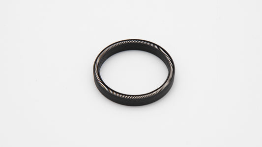 Round black object with spring installed