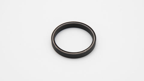 Round black object with spring installed