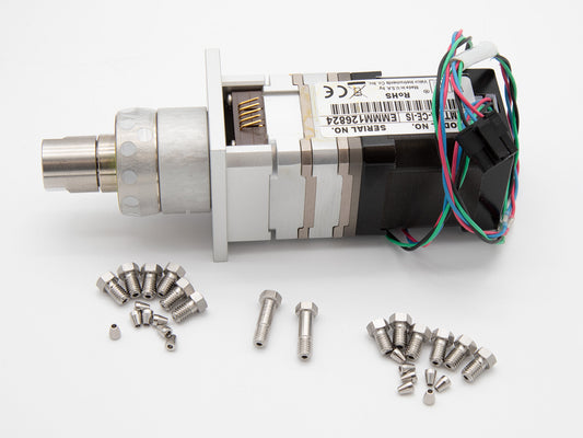 A motor surrounded by screws and nuts, all placed on a clean white surface, showcasing mechanical components.