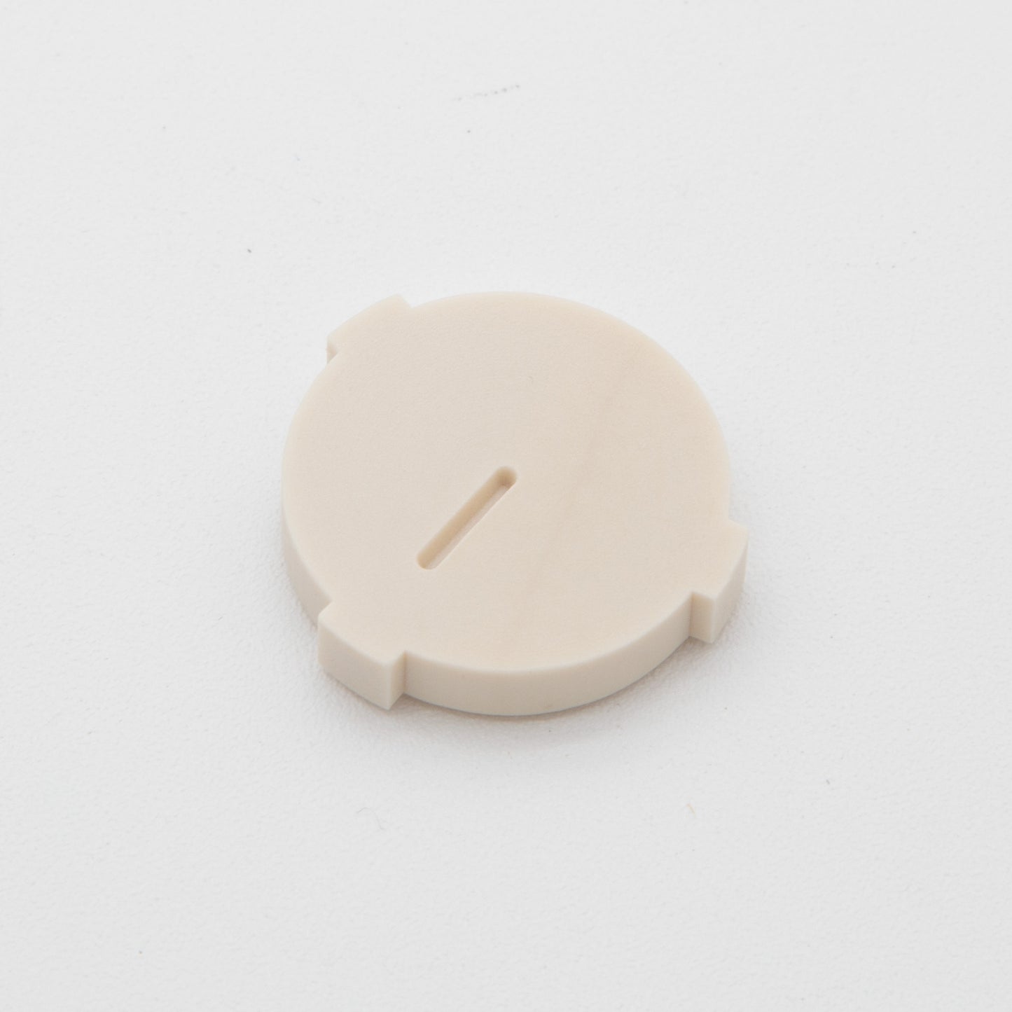 Tan colored circular plastic object