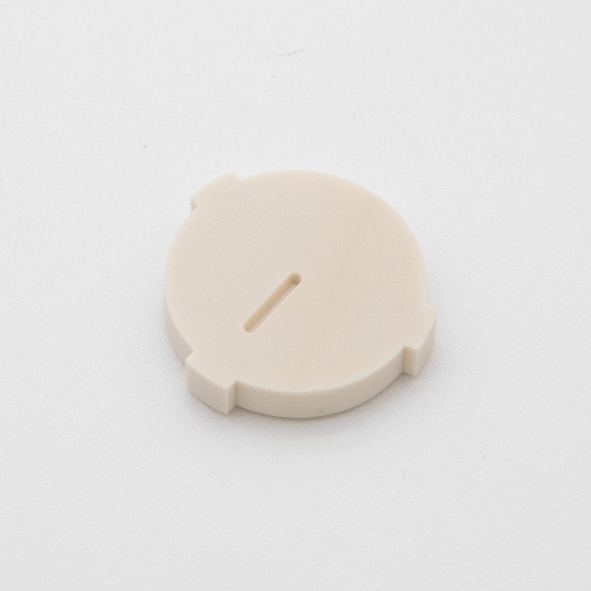 Tan colored circular plastic object