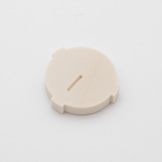 Tan colored circular plastic object