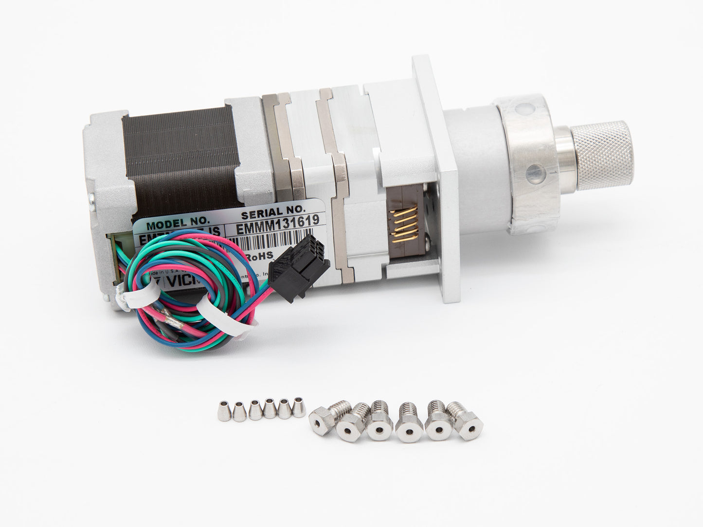 A valve assembly with screws placed on a clean white surface, showcasing their mechanical components and design.