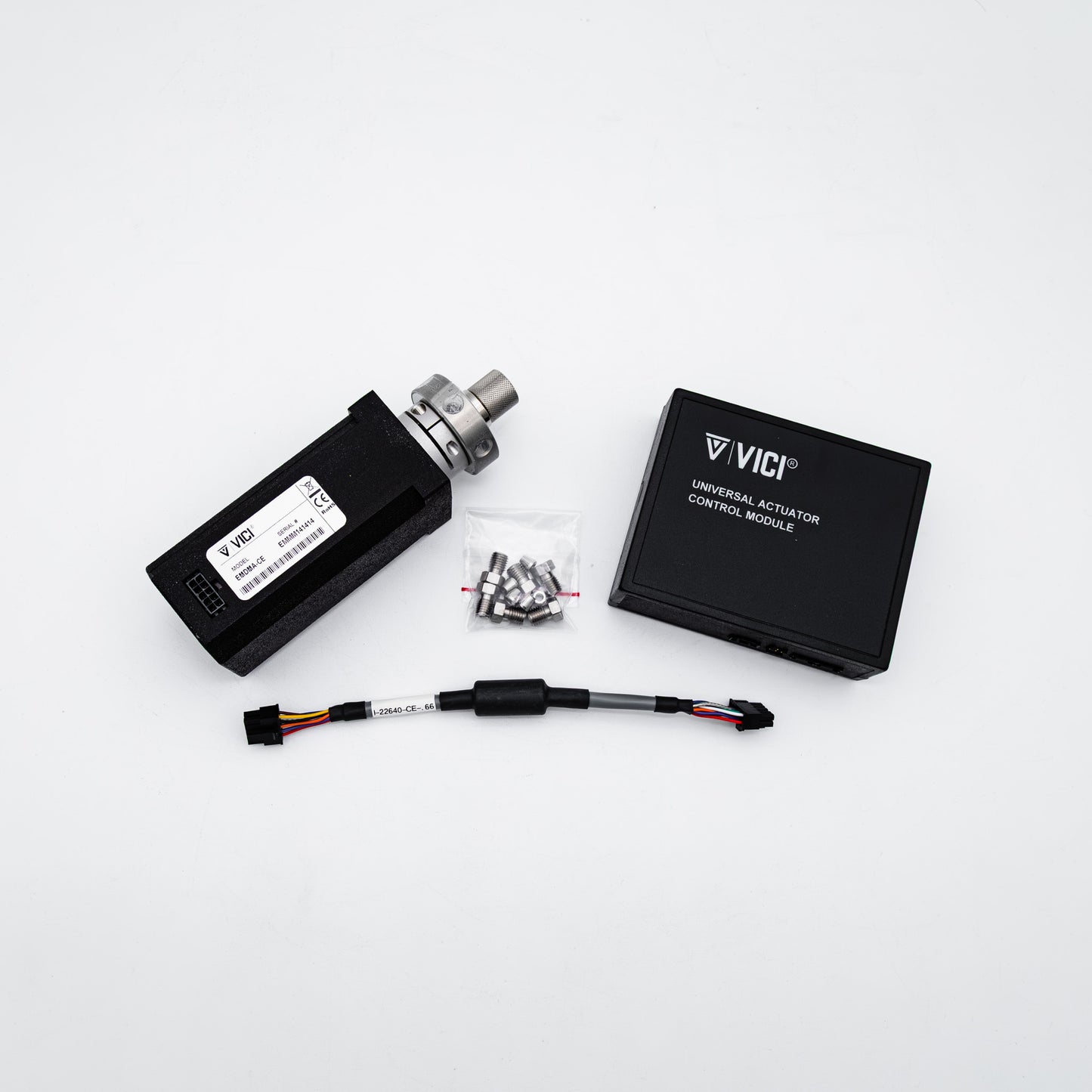 VICI Universal Actuator Control Module kit on a white background, including the black actuator body with metal fitting, black control module box, wiring harness, and small hardware bag.