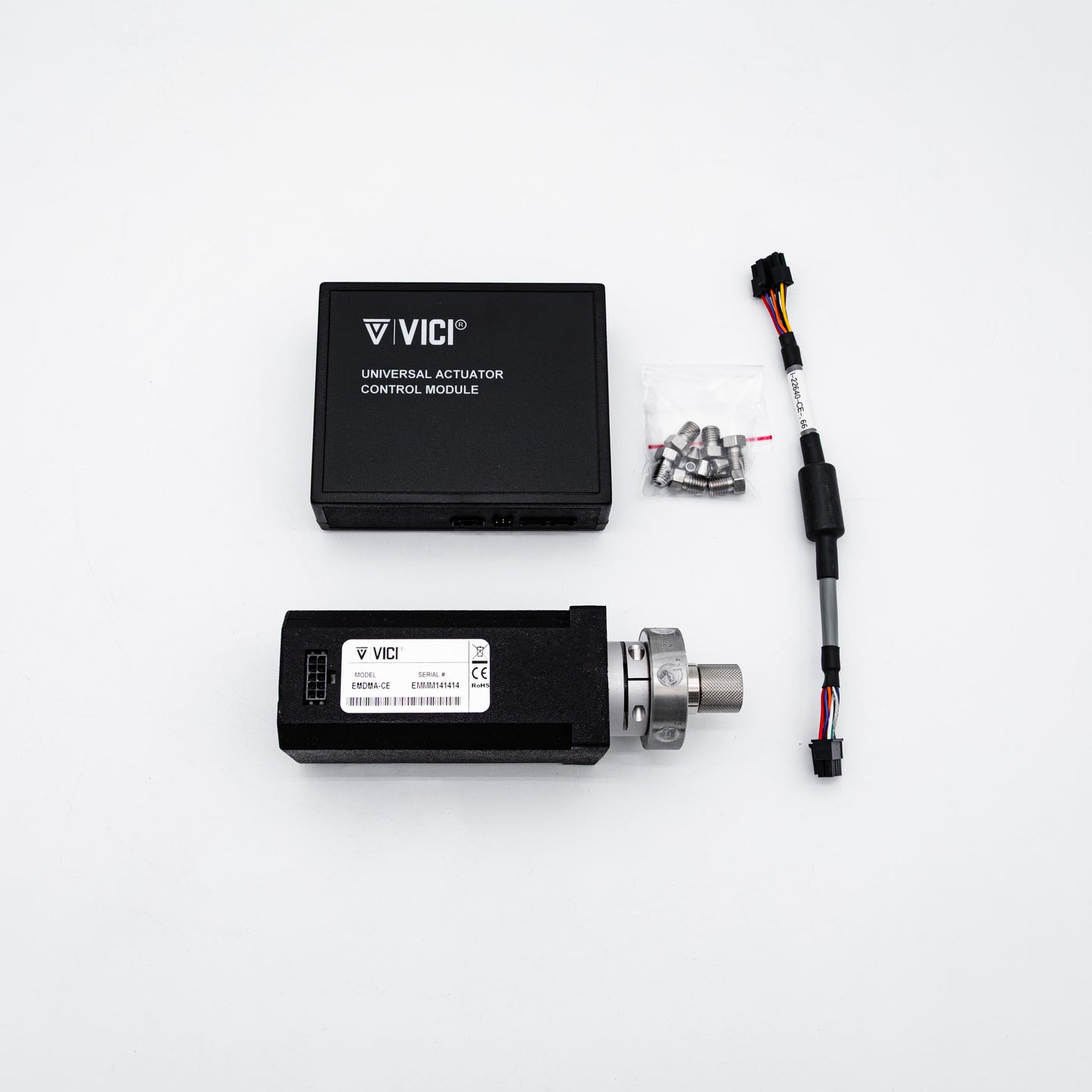 Vici universal actuator control module kit on a white background, including a black control module, a linear actuator with a silver metal rod, mounting hardware, and a wiring connector.