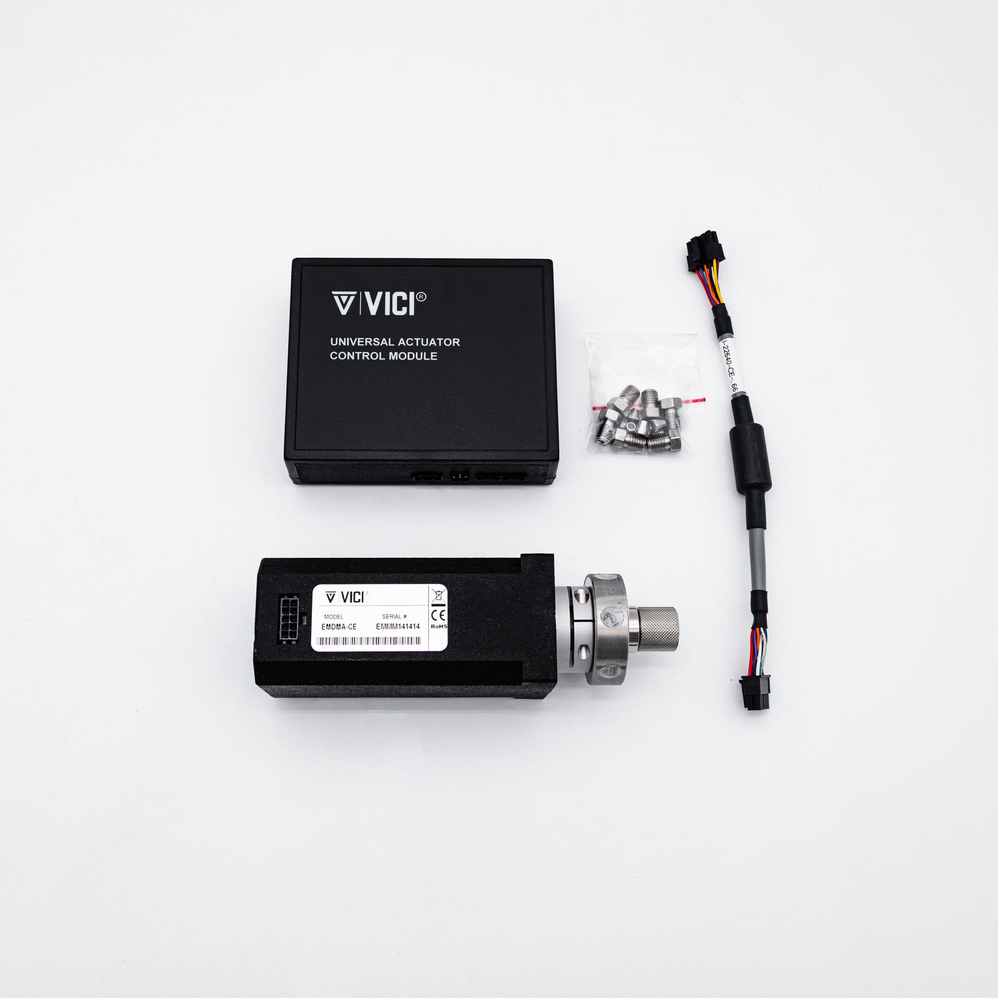 Vici universal actuator control module kit on a white background, including a black control module, a linear actuator with a silver metal rod, mounting hardware, and a wiring connector.