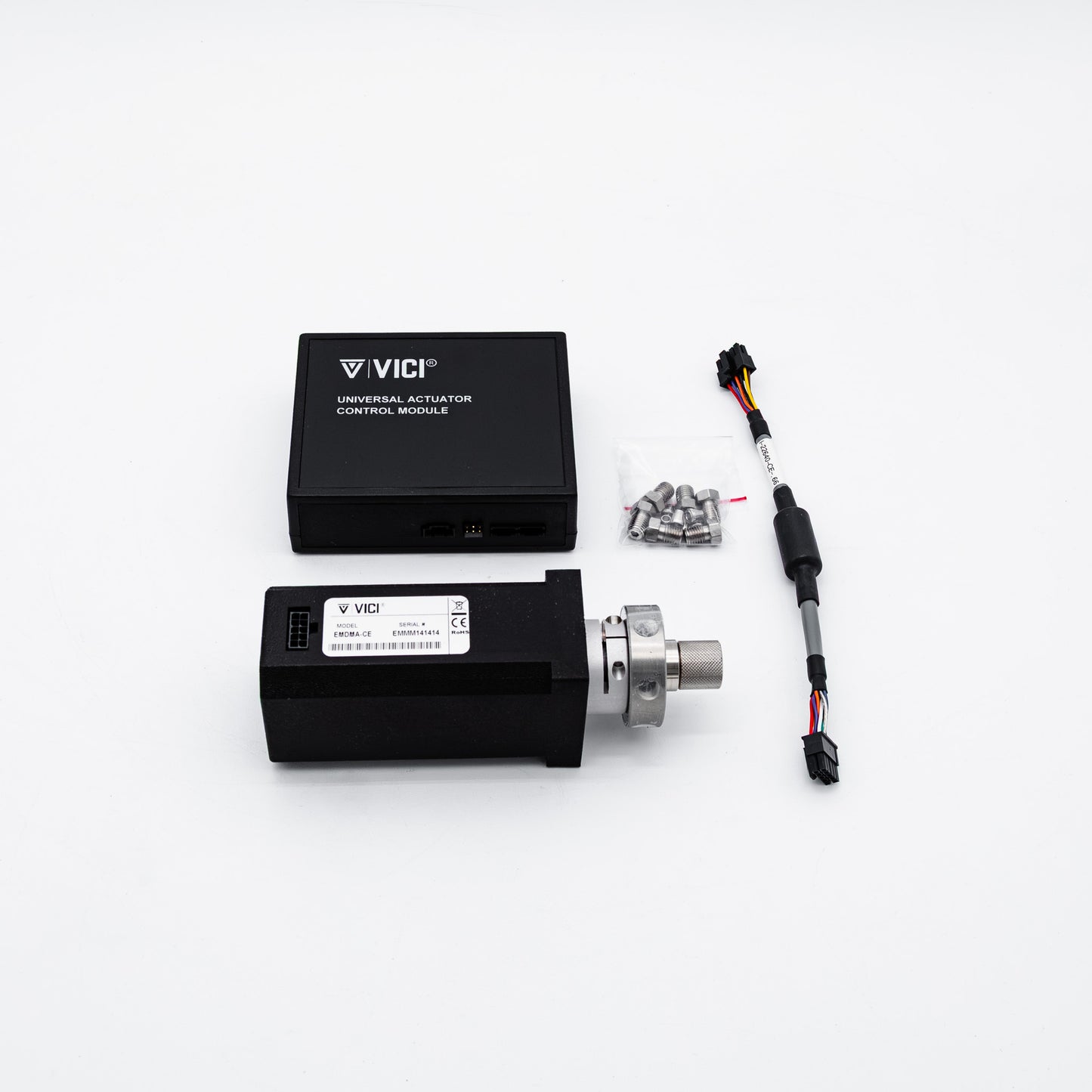 Vici universal actuator control module kit with two black plastic control modules, a small bag of mounting screws, and an electrical connector wire on a clean white background.