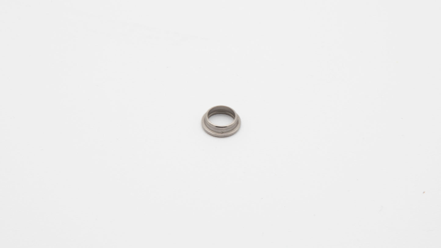 A silver round object on a white surface