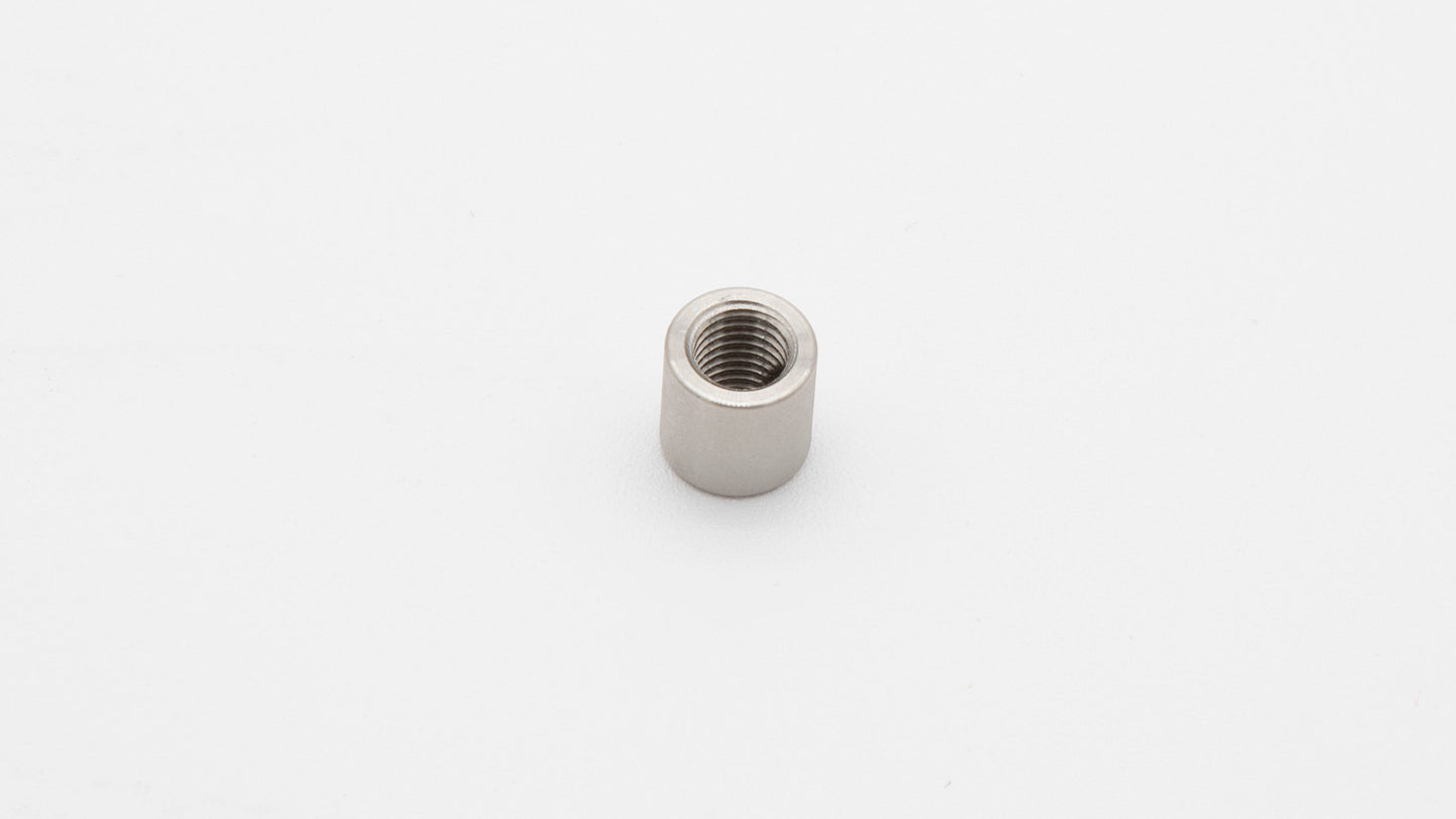 A small metal nut with a thread