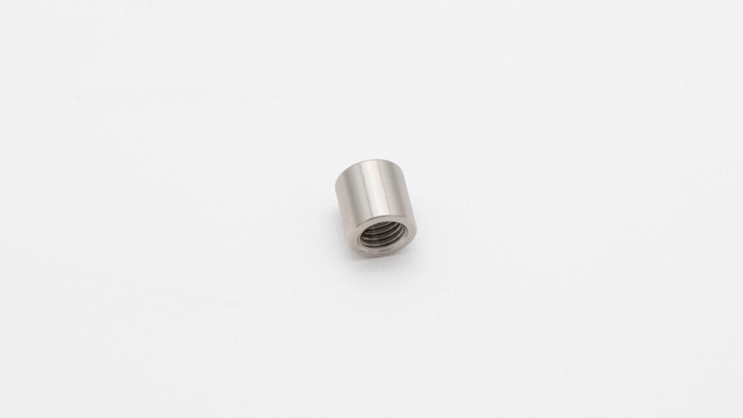 A small metal nut with a thread