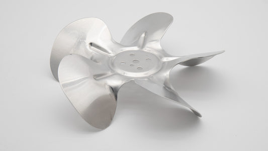 A close-up view of a propeller blade resting on a clean white surface, showcasing its sleek design and metallic finish.