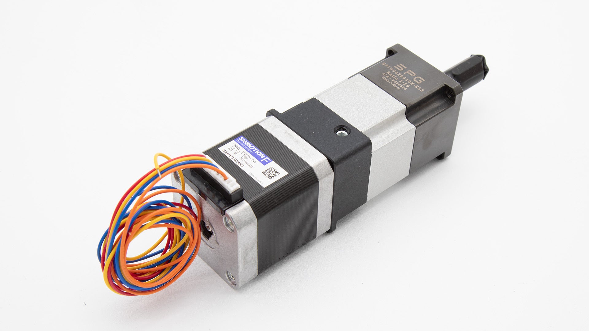 A stepper motor featuring multiple wires and a connecting cable, showcasing its intricate design and functionality.