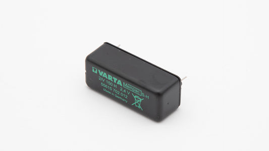 A black and green battery positioned on a clean white background, showcasing its distinct color contrast.