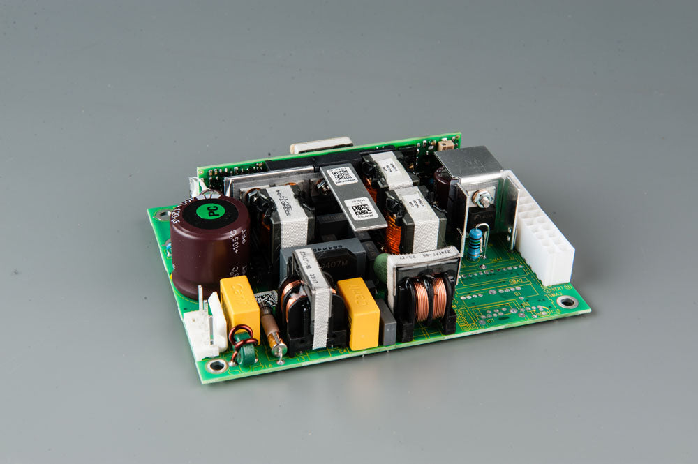 A compact electronic circuit board featuring a power supply component, showcasing its intricate design and functionality.