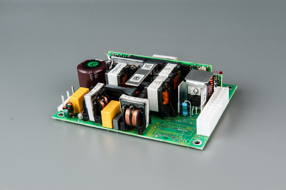 A compact electronic circuit board featuring a power supply component, showcasing its intricate design and functionality.