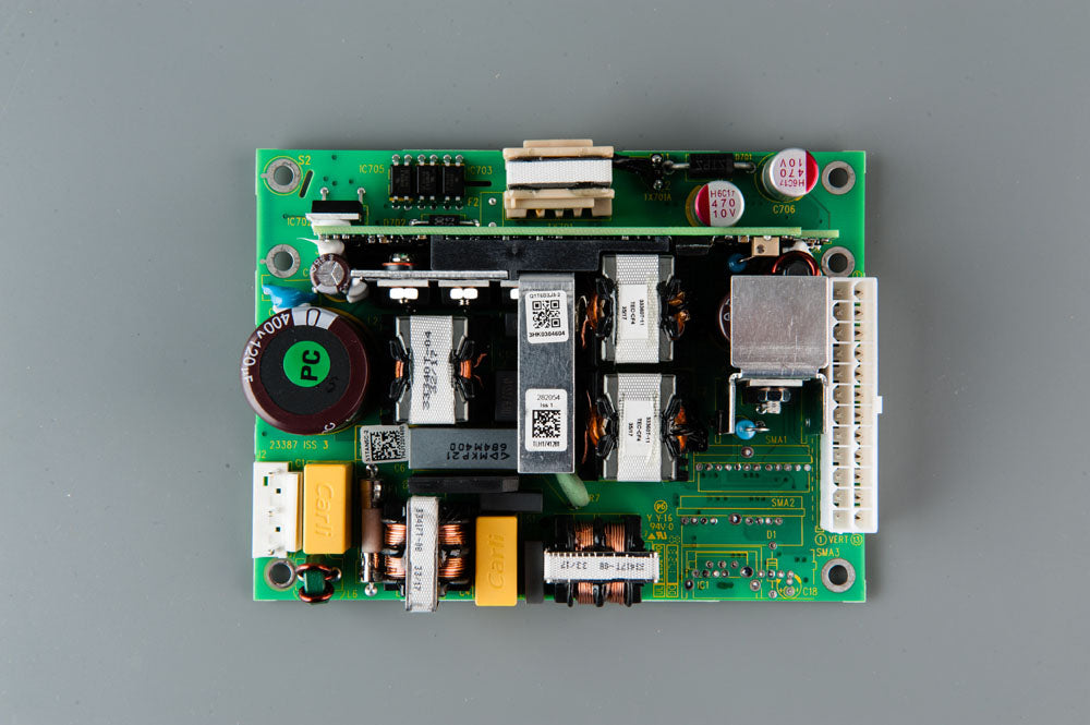 A compact electronic circuit board featuring a power supply component, showcasing its intricate design and functionality.