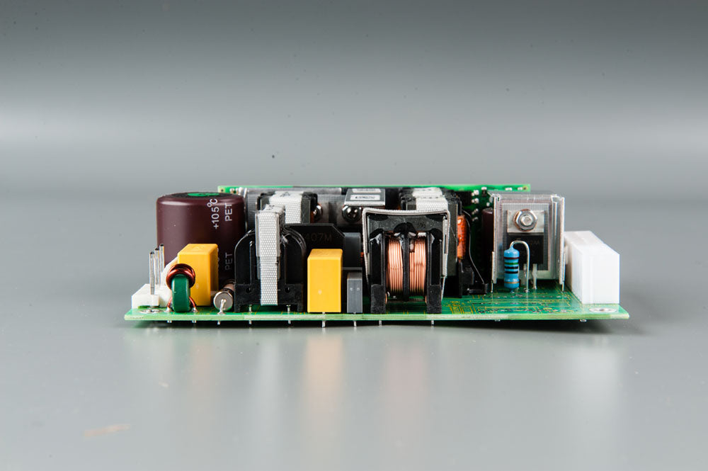 A compact electronic circuit board featuring a power supply component, showcasing its intricate design and functionality.