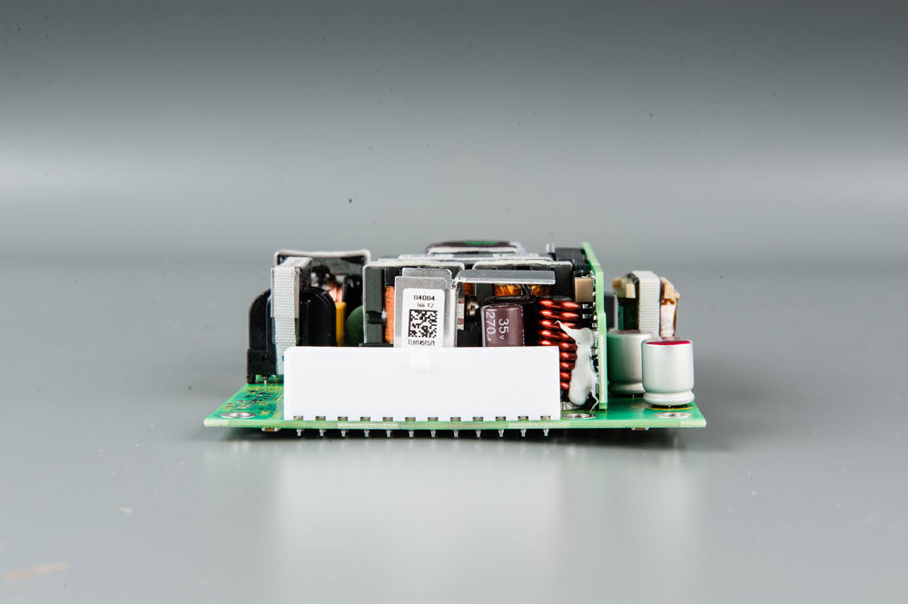 A compact electronic circuit board featuring a power supply component, showcasing its intricate design and functionality.