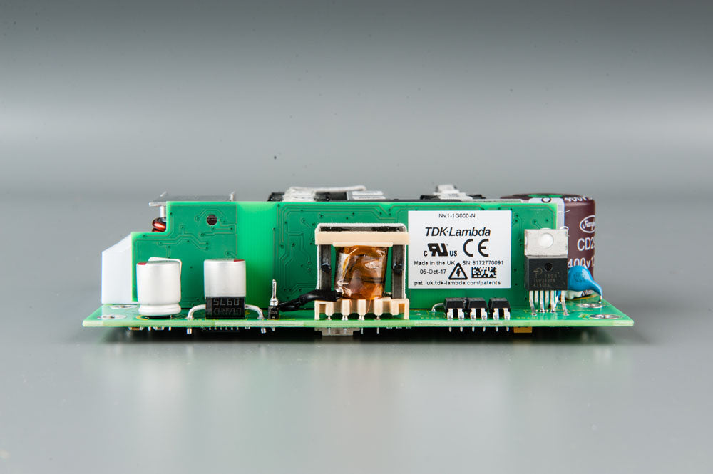 A compact electronic circuit board featuring a power supply component, showcasing its intricate design and functionality.