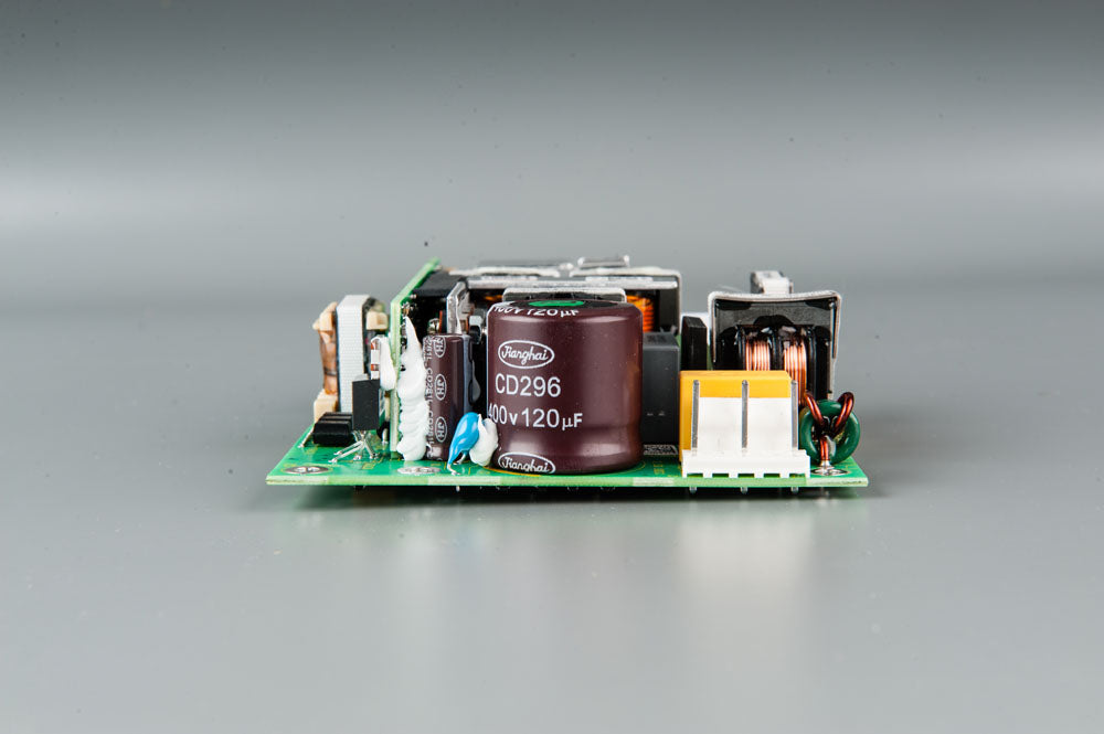 A compact electronic circuit board featuring a power supply component, showcasing its intricate design and functionality.