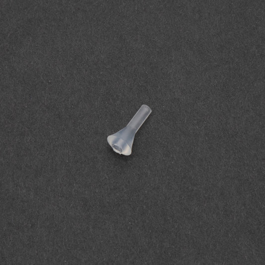A small clear plastic object rests on a smooth black surface, creating a striking contrast in color and texture.