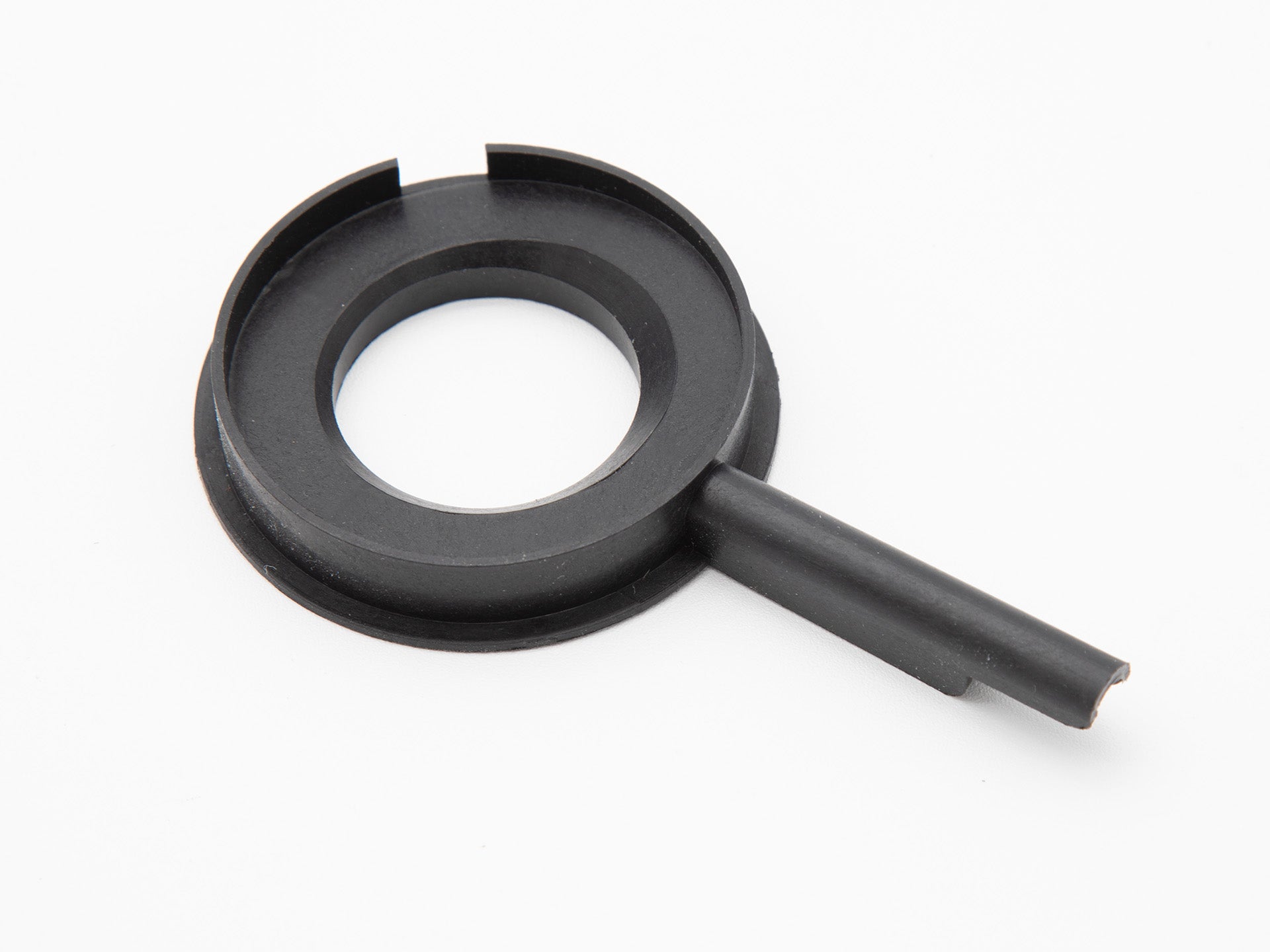 A round black plastic object with handle.