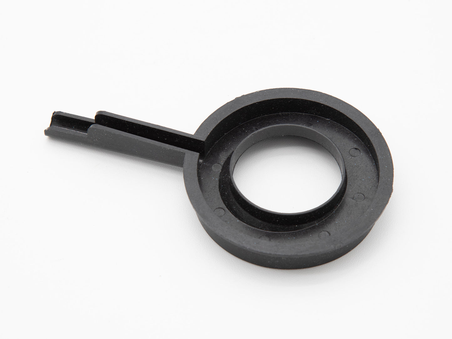 A round black plastic object with handle.