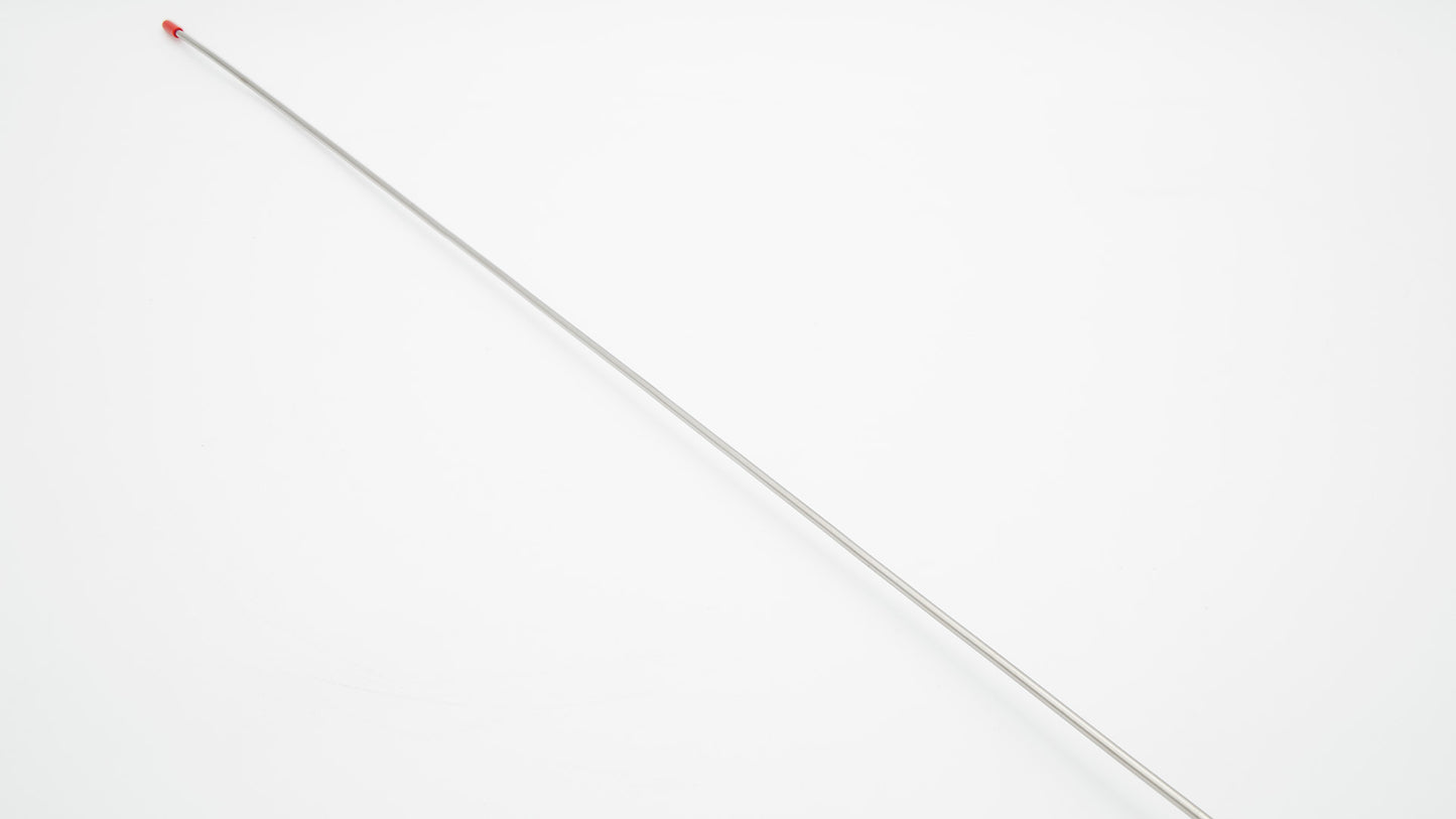 A long silver needle on a white surface