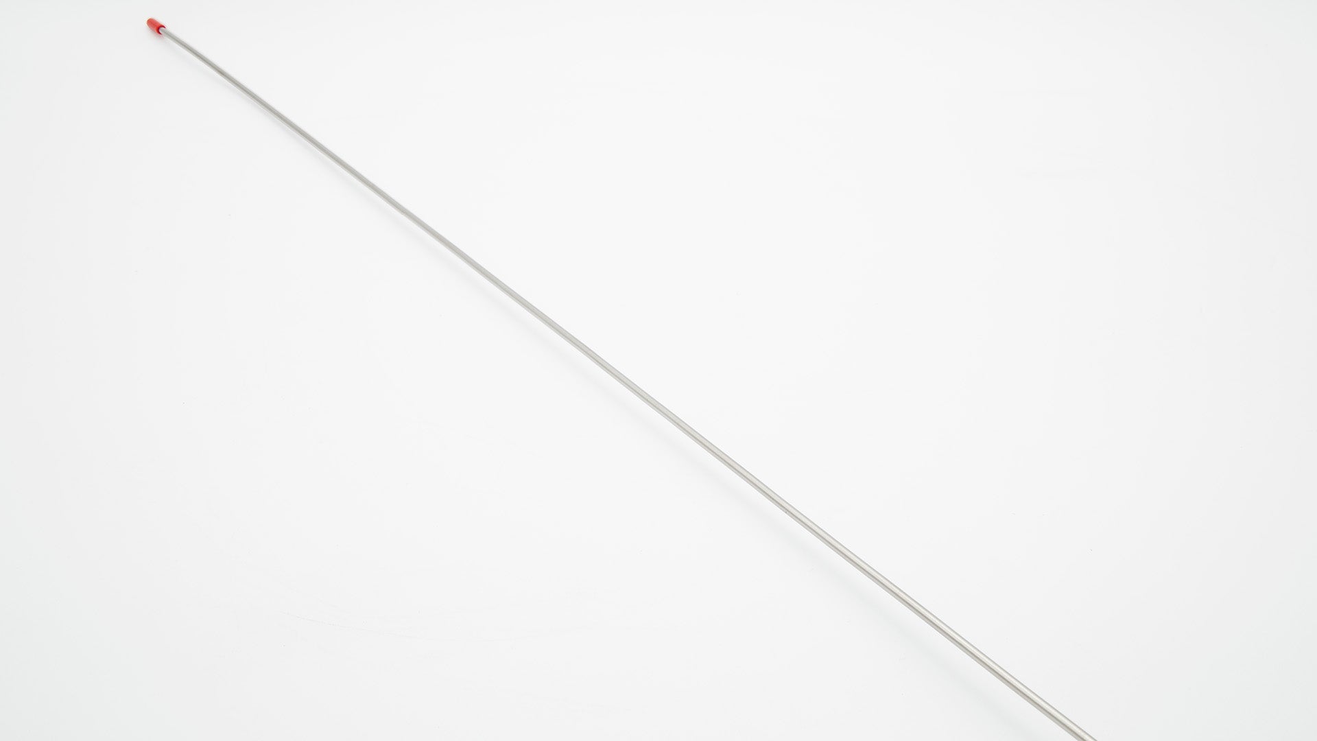 A long silver needle on a white surface