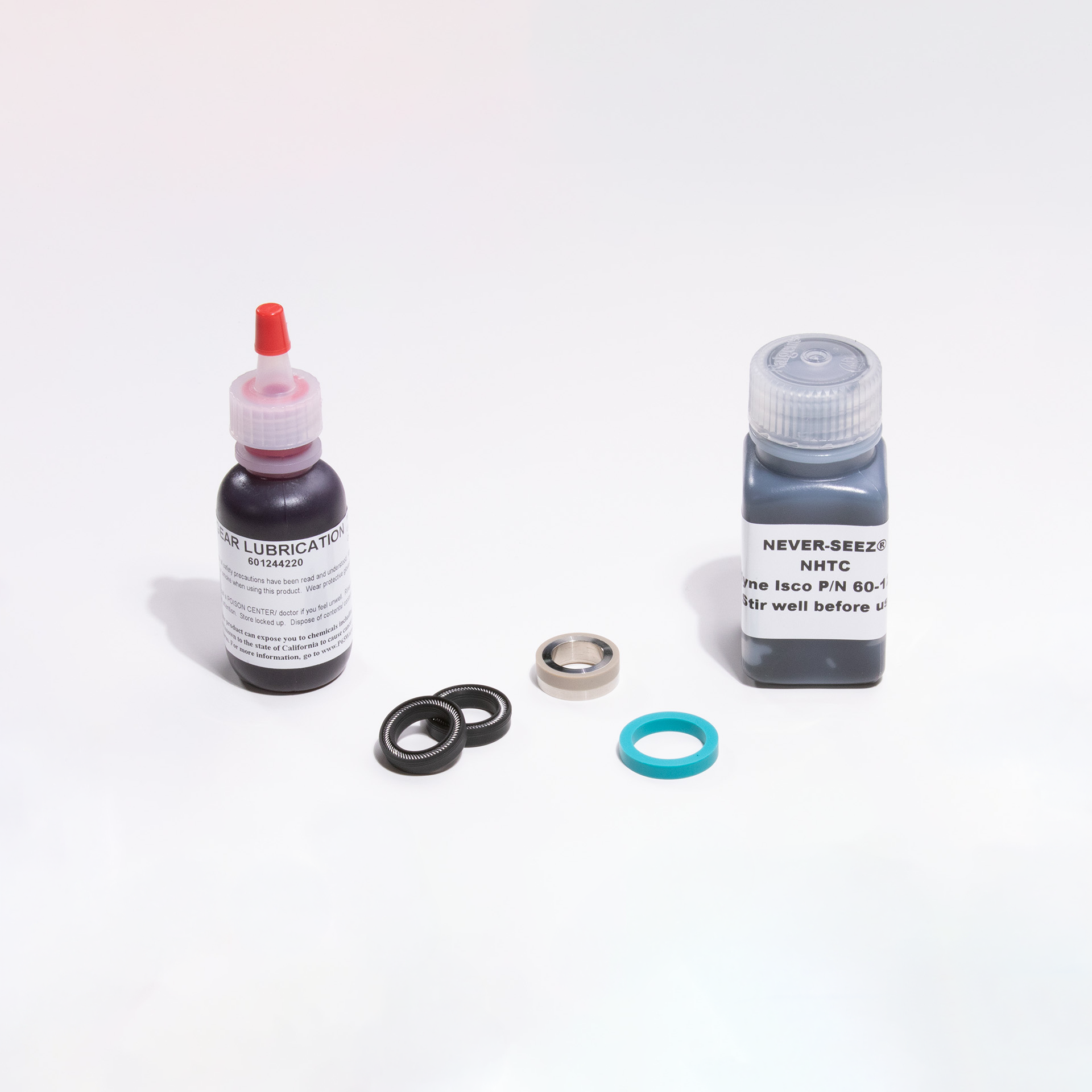 Two bottles of lubricant and filter parts on a white background