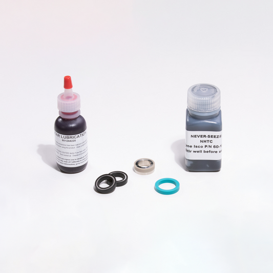 Two bottles of lubricant and filter parts on a white background