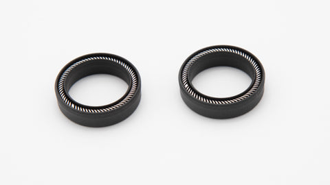 Two round black seals with installed springs