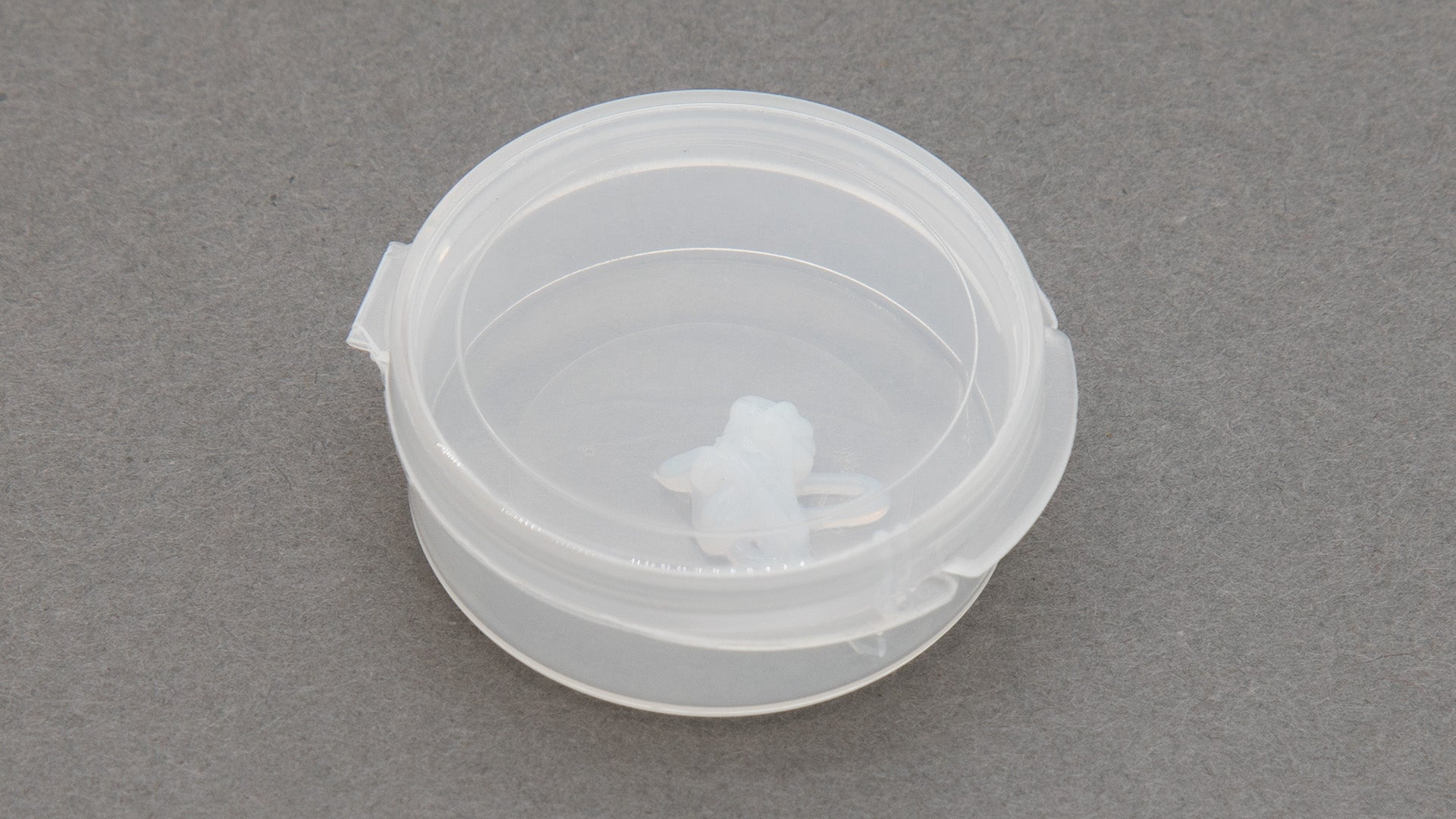 A round clear plastic container