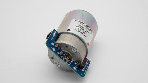 A small round motor with a blue circuit board