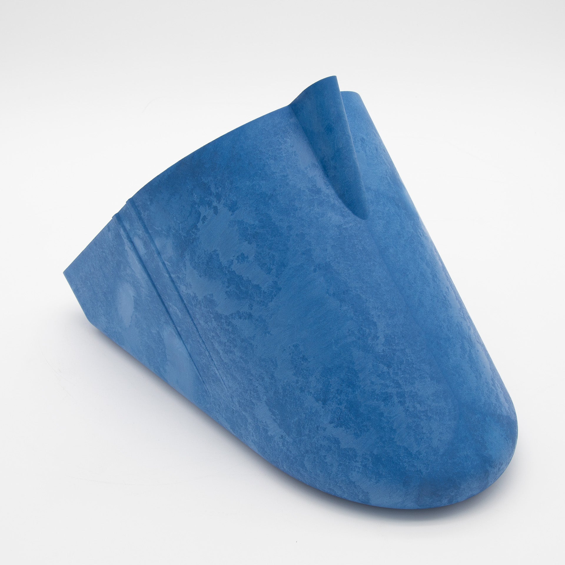 A blue plastic object featuring a central hole, showcasing its unique design and material.