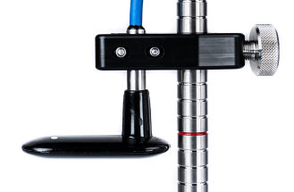 A metal pole with a blue cord securely fastened to its side, standing upright against a neutral background.