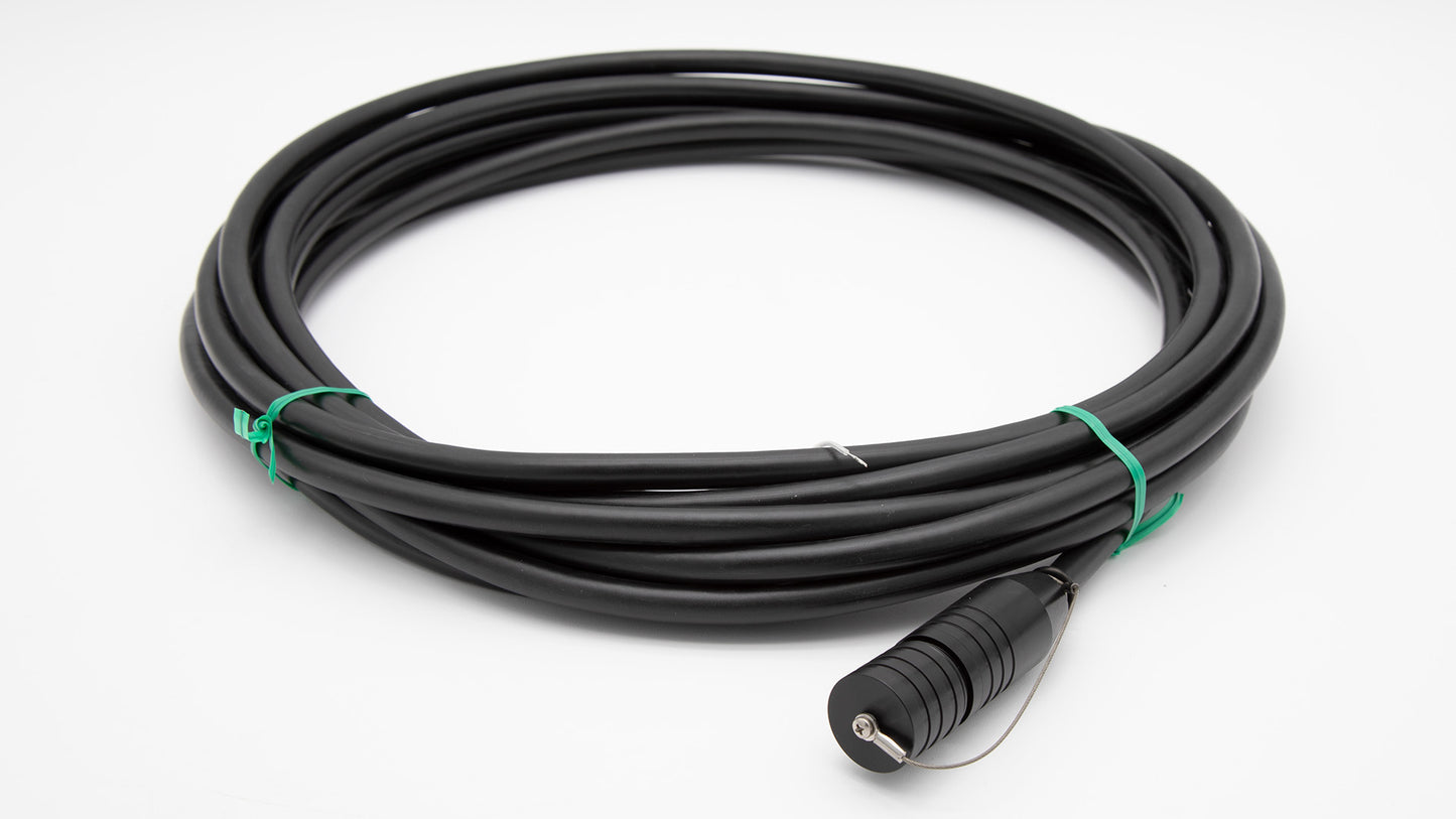 A black cable intertwined with a green cord, set against a clean white background.