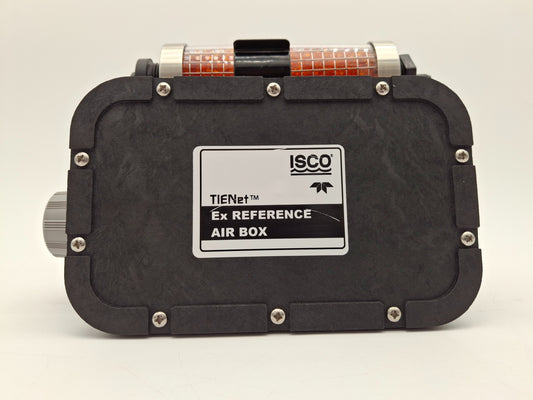 Close-up image featuring a black box and component with an orange object, emphasizing the contrast between materials and color.