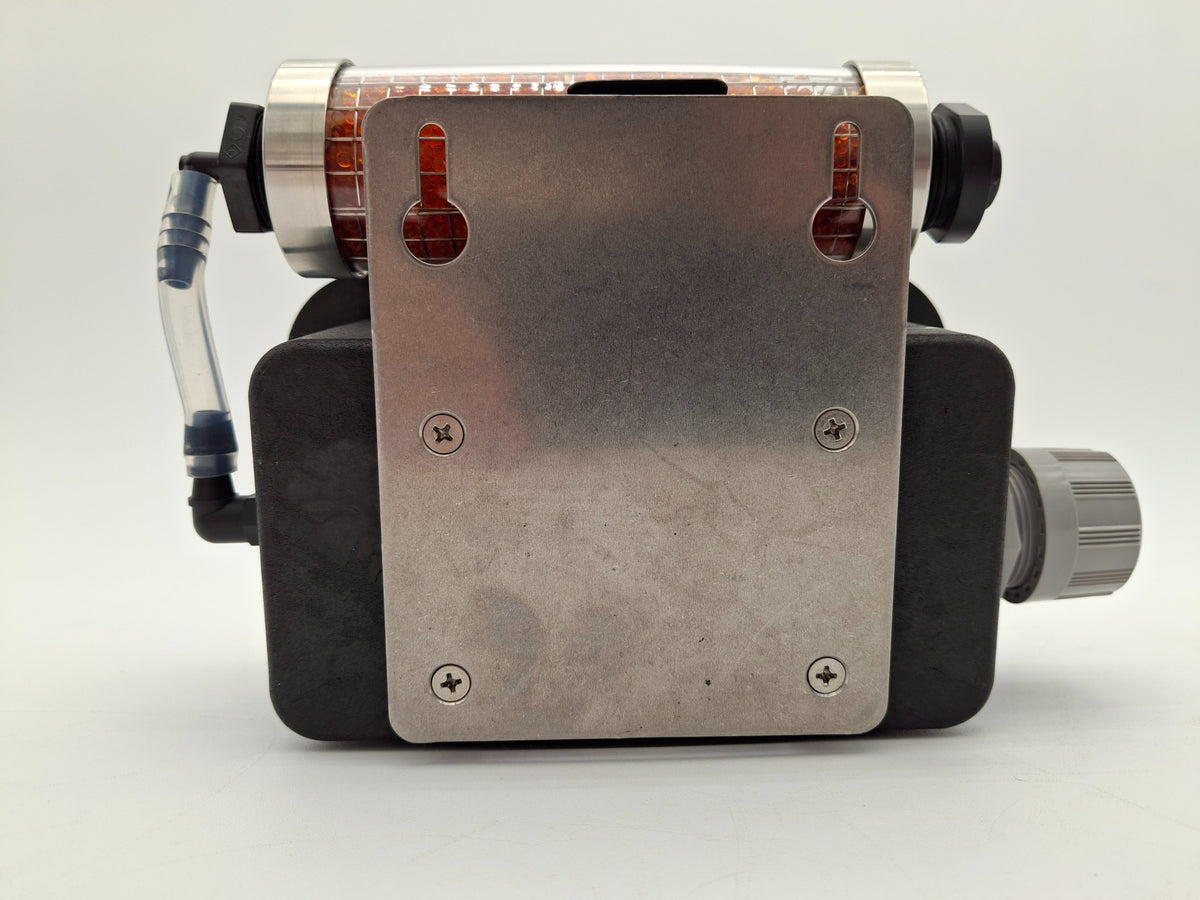 Close-up image featuring a metal component with an orange object, emphasizing the contrast between materials and color.