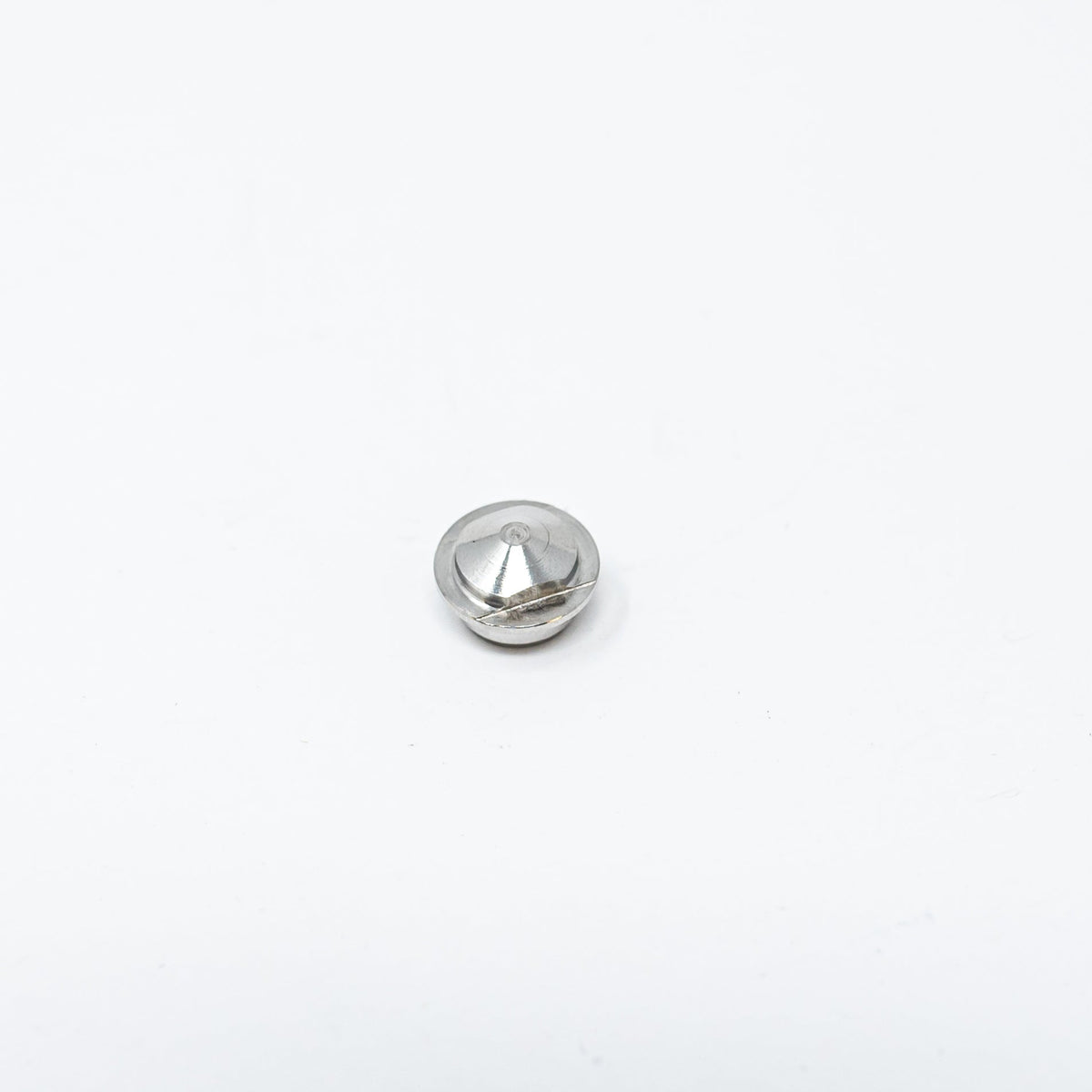A small metal nut resting on a clean white surface, showcasing its shiny texture and circular shape.