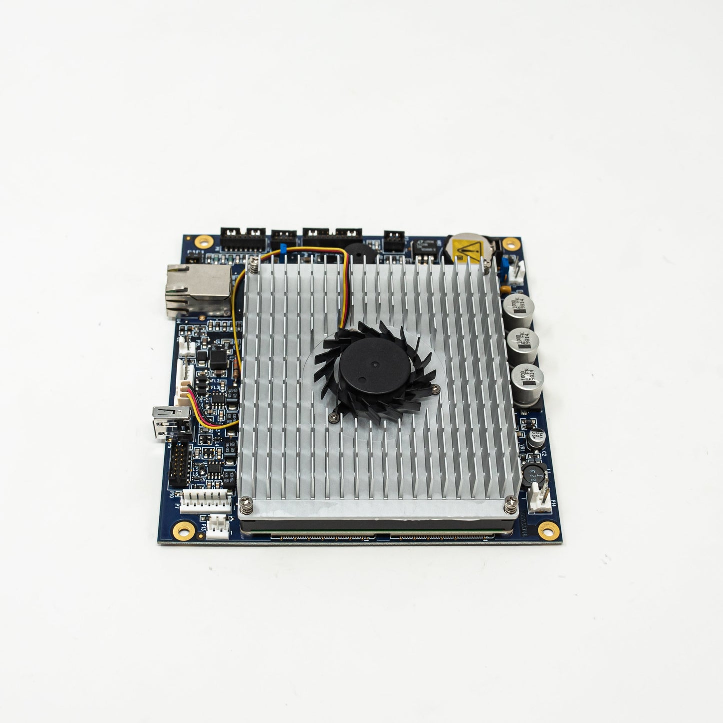 A small circuit board featuring a cooling fan, showcasing its compact design and essential electronic components.