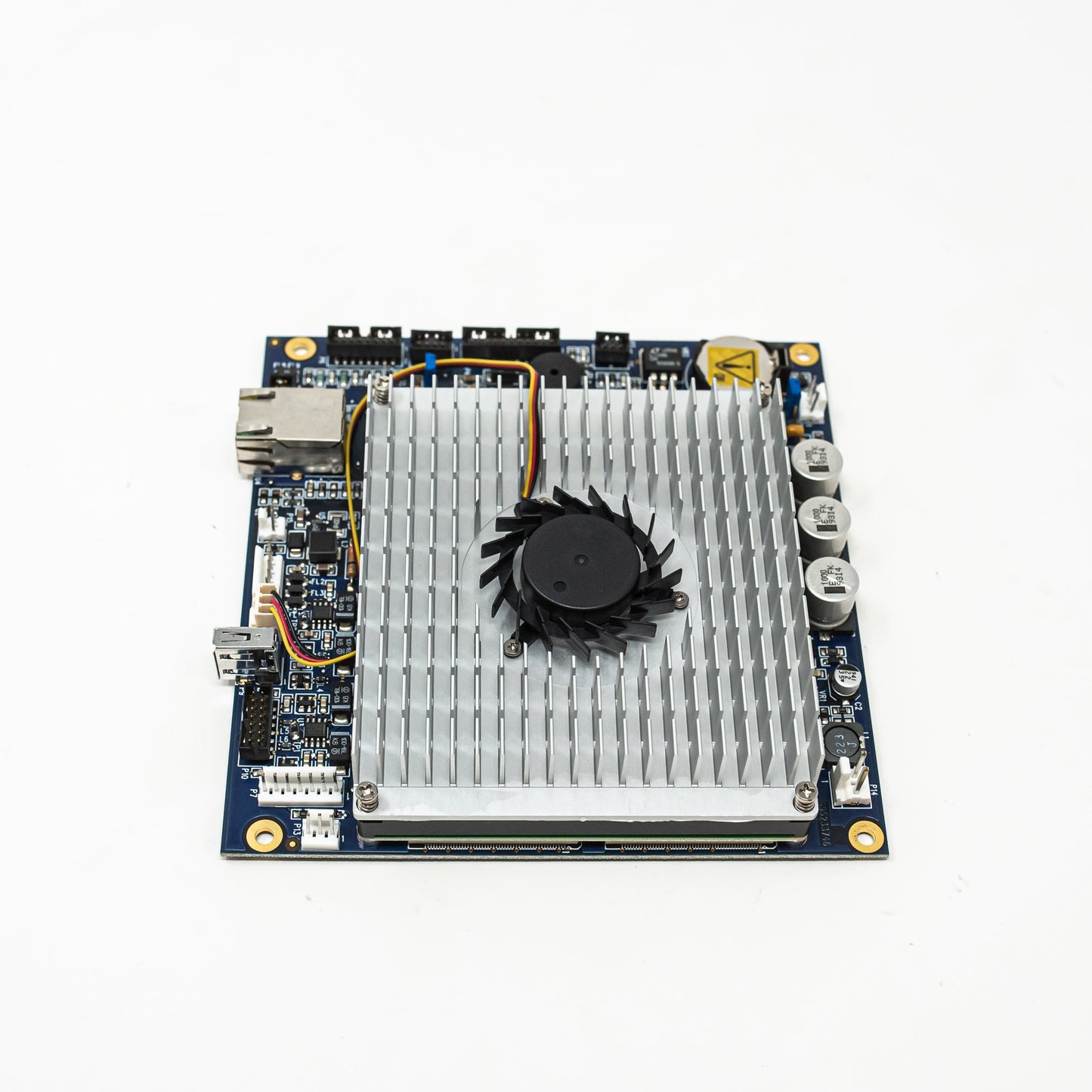 A small circuit board featuring a cooling fan, showcasing its compact design and essential electronic components.