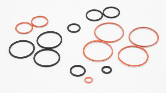 A collection of orange and black round objects in varied sizes