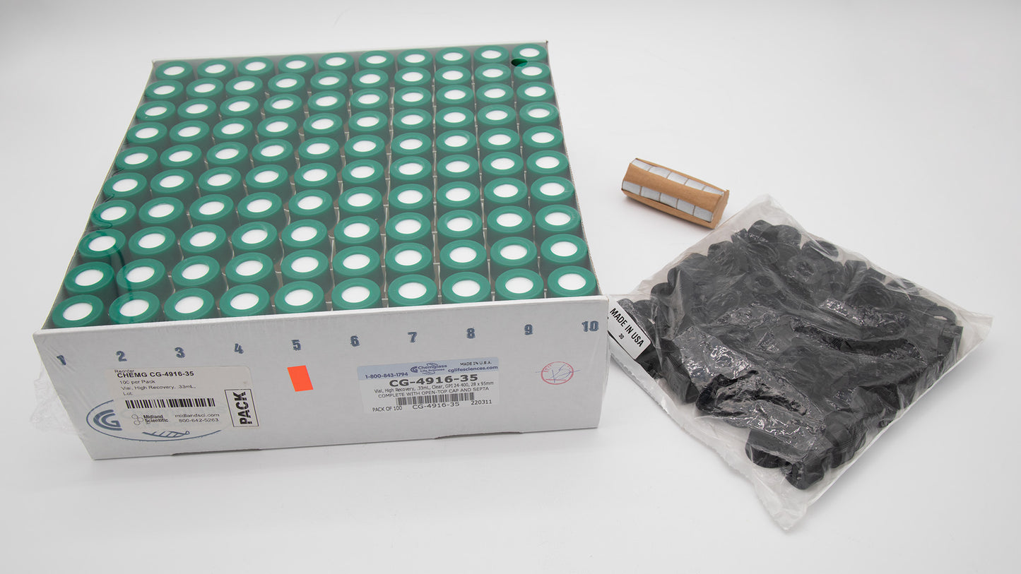 A box with vials alongside a bag with caps and a package of foil discs intended for use in a laboratory setting.