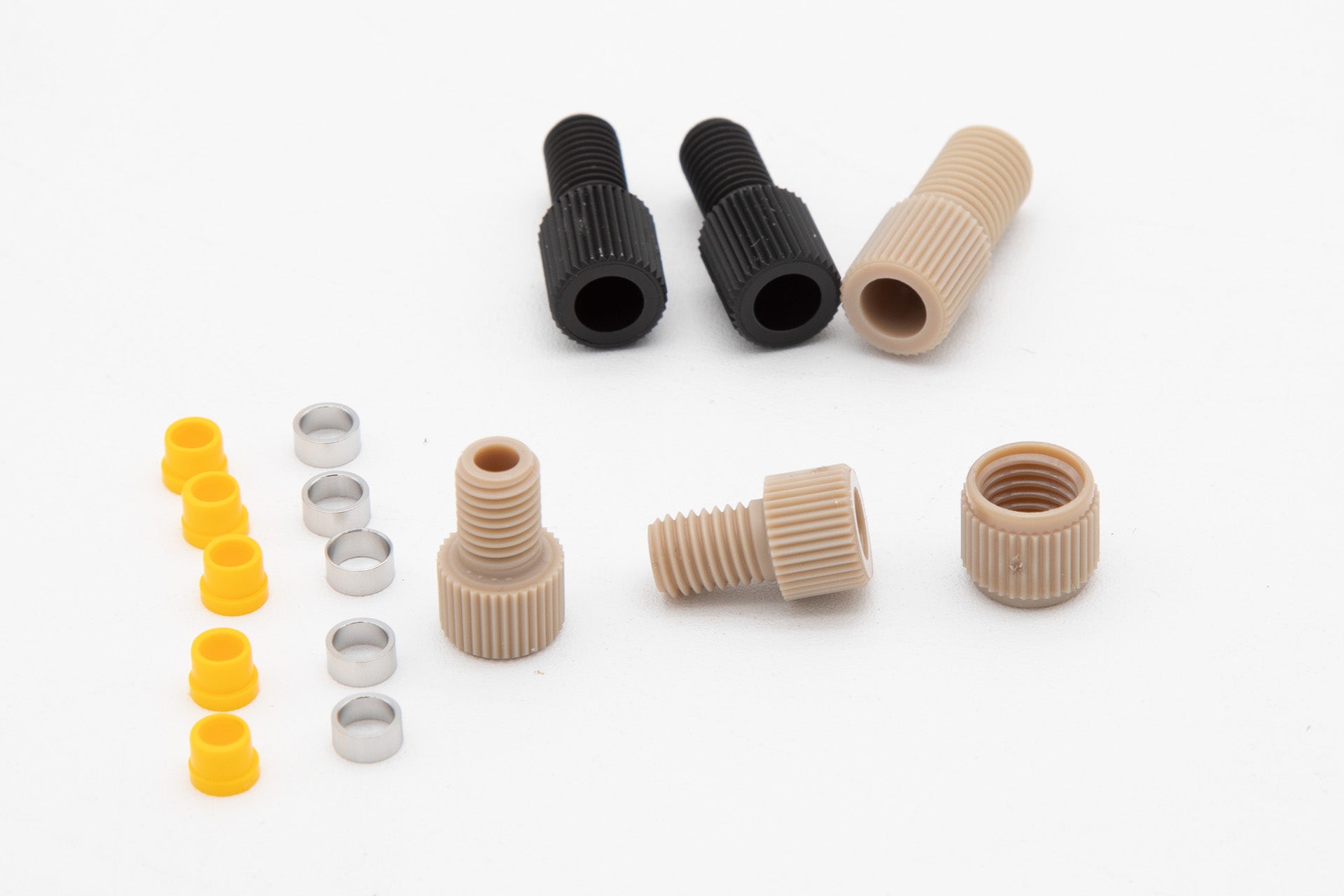 A collection of assorted plastic fittings and screws arranged neatly for easy identification and selection.